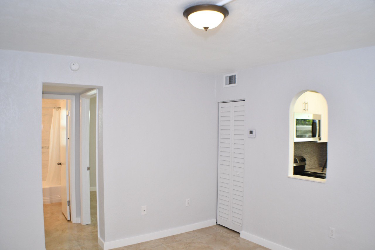 Living area with bathroom and closet view